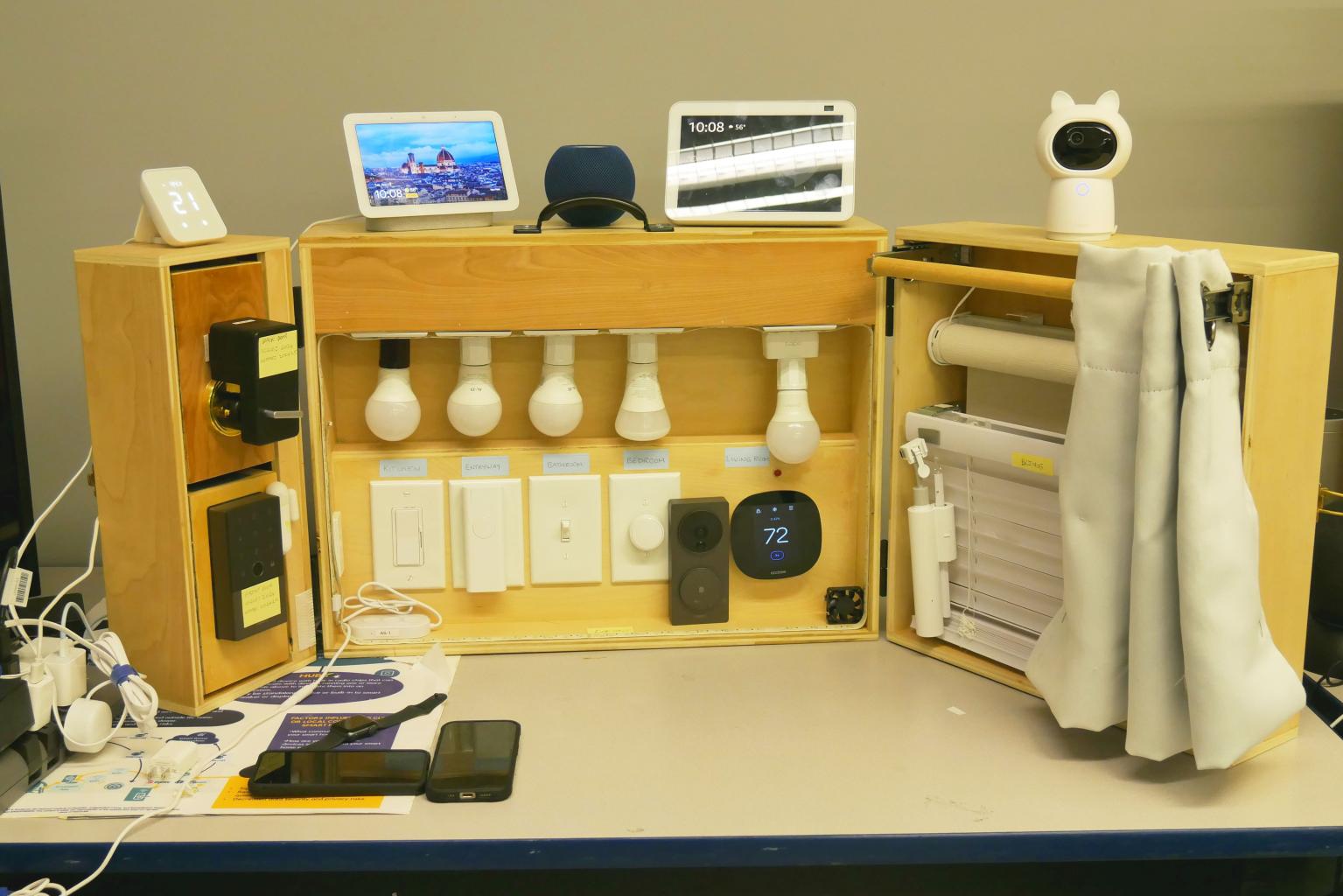 Photo of the SmartTech Demo Station with Door Locks, Light Bulbs, Cameras, Curtains, and other misc. home tech