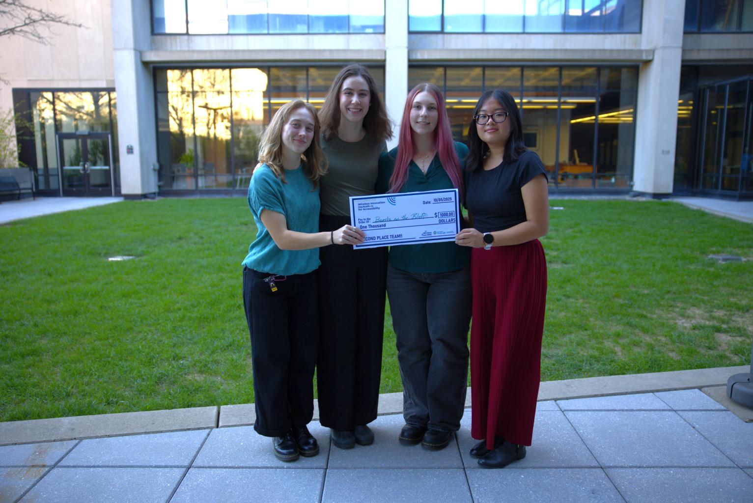"Duquesne Students from Beasts on the Bluff stand and celebrate with an oversized $1000 check."